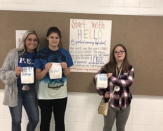 Neighbors | Submitted.For Start With Hello Week Kindness club advisor Lindsay Ignazio along with club members Angel O’Grady and Christin Murcko handed out bags of popcorn with positive quotes on them to students of Poland high school.