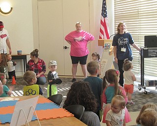 Neighbors | Jessica Harker.Librarian Lindsay Cramer led children in a dance along to the "Paw Patrol" theme song to kick off the party at the Austintown library.