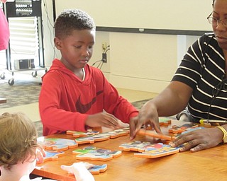Neighbors | Jessica Harker.Jeremiah Burt worked to complete a puzzle during the "Paw Patrol" party at the Austintown library.