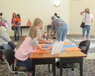 Neighbors | Jessica Harker.Children played at different stations set up around the Austintown library's meeting room for a "Paw Patrol" themed party.