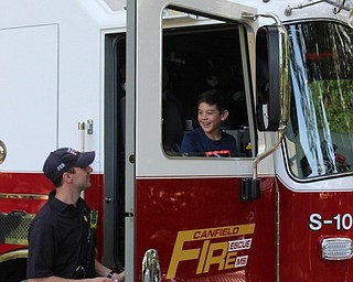 Neighbors | Abby Slanker.A Hilltop Elementary School third-grade student got a thrill of a lifetime as he climbed into the cab of a Cardinal Joint Fire District fire truck as firefighter/paramedic John Corman looked on.