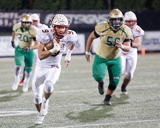 Cardinal Mooney's Jason Santisi runs with the ball during the first half of their game against Ursuline at Stambaugh Studium on Friday. EMILY MATTHEWS | THE VINDICATOR