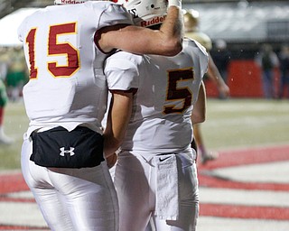 Cardinal Mooney's John Murphy (15) and Nico Marchionda (5) celebrate after Marchionda scores a touchdown during the first half of their game against Ursuline at Stambaugh Studium on Friday. EMILY MATTHEWS | THE VINDICATOR