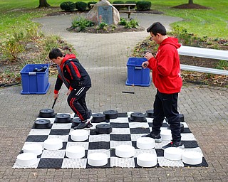 Brothers Rocco Cocca, 9, left, and Santino Cocca, 12, both of Canfield, play checkers at the Canfield Police Department's Fall Festival on Saturday. EMILY MATTHEWS | THE VINDICATOR