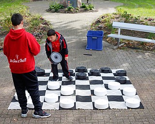 Brothers Santino Cocca, 12, left, and Rocco Cocca, 9, both of Canfield, play checkers at the Canfield Police Department's Fall Festival on Saturday. EMILY MATTHEWS | THE VINDICATOR