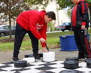 Brothers Santino Cocca, 12, left, and Rocco Cocca, 9, both of Canfield, play checkers at the Canfield Police Department's Fall Festival on Saturday. EMILY MATTHEWS | THE VINDICATOR