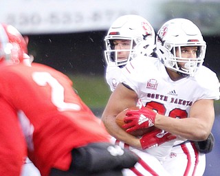 South Dakota's Ben Klett runs with the ball during the first half of their game against Youngstown State at Stambaugh Stadium on Saturday. EMILY MATTHEWS | THE VINDICATOR