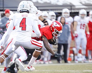 YSU's Jermiah Braswell holds onto the ball as he gets tackled by South Dakota during the first half of their game at Stambaugh Stadium on Saturday. EMILY MATTHEWS | THE VINDICATOR
