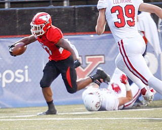 YSU's Tevin McCaster gets past South Dakota's Alex Gray and scores a touchdown during the first half of their game at Stambaugh Stadium on Saturday. EMILY MATTHEWS | THE VINDICATOR