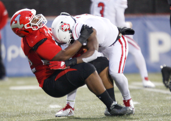 YSU's Savon Smith tackles South Dakota's Kai Henry during the first half of their game at Stambaugh Stadium on Saturday. EMILY MATTHEWS | THE VINDICATOR