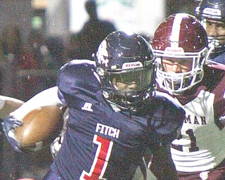 Austintown Fitch’s Ralph Fitzgerald (1) eludes Boardman’s Cam Kreps (21) on a first-half pass reception Friday night at Fitch Falcon Stadium. The Falcons beat the Spartans, 21-20.