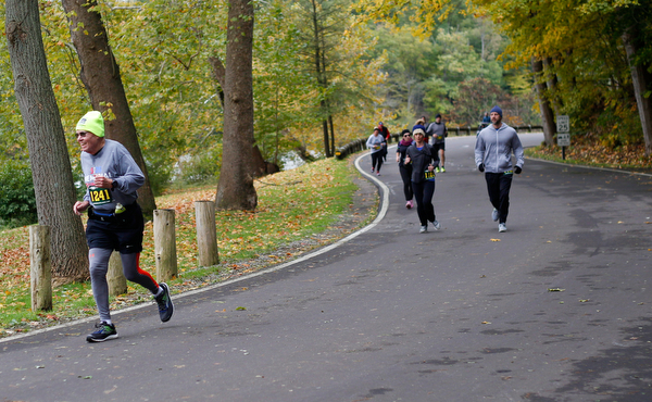 Richard Hanks, left, of Niles, runs through Mill Creek Park with others during the Youngstown Peace Race 10K on Sunday morning. EMILY MATTHEWS | THE VINDICATOR