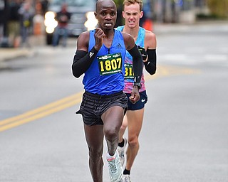 YOUNGTSOWN, OHIO - OCTOBER 21, 2018: Dennis Kipkosgei, front, runs to the finish line ahead of Ryan Robinson to win the 2018 Peace Race, Sunday morning in Youngstown. DAVID DERMER | THE VINDICATOR