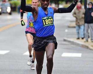 YOUNGTSOWN, OHIO - OCTOBER 21, 2018: Dennis Kipkosgei, front, runs to the finish line ahead of Ryan Robinson to win the 2018 Peace Race, Sunday morning in Youngstown. DAVID DERMER | THE VINDICATOR