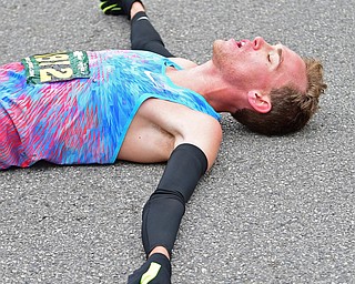 YOUNGTSOWN, OHIO - OCTOBER 21, 2018: Ryan Robinson catches his breath while resting on the pavement after completing the 2018 Peace Race, Sunday morning in Youngstown. DAVID DERMER | THE VINDICATOR