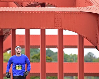 YOUNGTSOWN, OHIO - OCTOBER 21, 2018: Patrick Jennings runs across the Spring Common Bridge on his way to the finish line, Sunday morning in Youngstown. DAVID DERMER | THE VINDICATOR