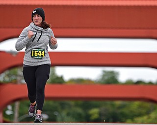 YOUNGTSOWN, OHIO - OCTOBER 21, 2018: A runner runs across the Spring Common Bridge on her way to the finish line, Sunday morning in Youngstown. DAVID DERMER | THE VINDICATOR