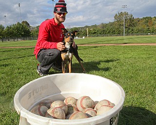 William D. Lewis The Vindicator YSU Baseball unofficial mascot, Ali, a dog the team adopted after it showed up at a recent practice. Player Jeff Wehler share a moment with Ali. Their coach likens the dog to the Brown's Rally Possum.