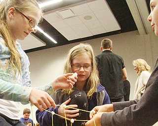 Canfield Hilltop elementary students, from left, Hannah Hicklin, Emily Glista and Jocelyn Smith build a tower out of pasta during the Cutting Edge Manufacturing Event at Mahoning County Career & Technical Center.