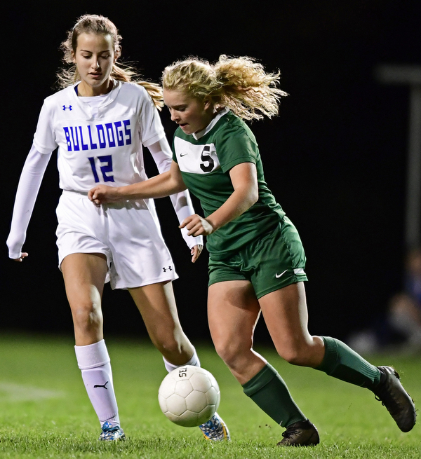 BELOIT, OHIO - OCTOBER 22, 2018: West Branch's Rilery Meslerplays the ball while being pressured by Poland's Molly Malmer during the first half of their game, Monday night at West Branch High School. DAVID DERMER | THE VINDICATOR