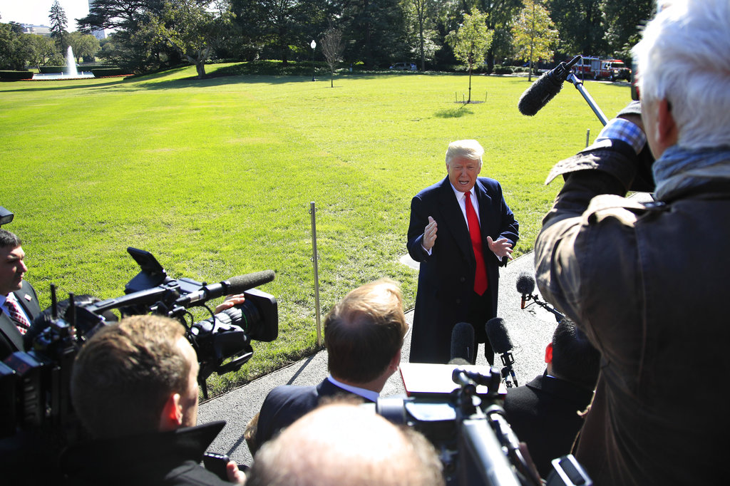 President Donald Trump speaks to reporters before leaving the White House in Washington on Monday to attend a campaign rally in Houston, Texas. Trump is looking to push a middle-income tax cut through Congress soon.