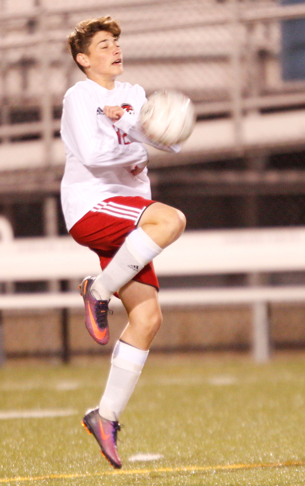 Canfield's Matt Beck attempts to knee the ball during their game at Hubbard on Tuesday night. EMILY MATTHEWS | THE VINDICATOR