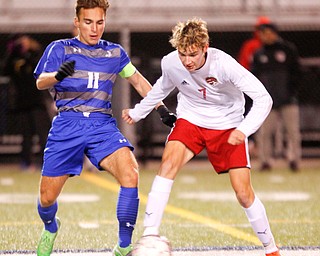 Hubbard's Michael VanSuch and Canfield's Aren Villano go after the ball during their game at Hubbard on Tuesday night. EMILY MATTHEWS | THE VINDICATOR