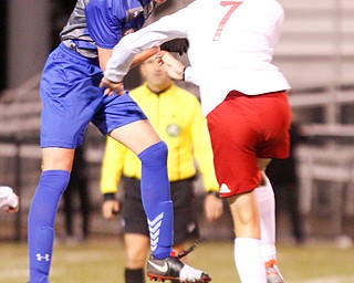 Hubbard's Jacob Gulu and Canfield's Aren Villano jump for the ball during their game at Hubbard on Tuesday night. EMILY MATTHEWS | THE VINDICATOR