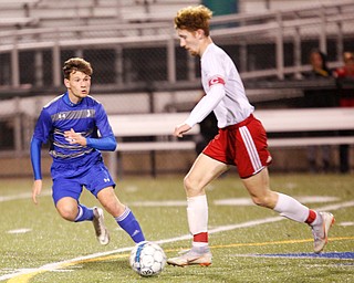 Hubbard's Sam Biro tries to keep the ball away from Canfield's Hunter Hale during their game at Hubbard on Tuesday night. EMILY MATTHEWS | THE VINDICATOR