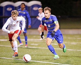 Hubbard's Michael VanSuch and Canfield's Aren Villano go after the ball during their game at Hubbard on Tuesday night. EMILY MATTHEWS | THE VINDICATOR