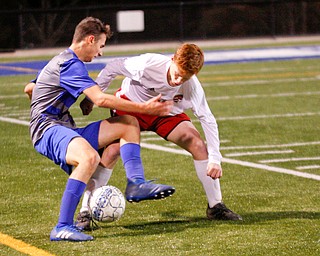 Hubbard's Ivan Affiticati and Canfield's Jake Johnson battle for the ball during their game at Hubbard on Tuesday night. EMILY MATTHEWS | THE VINDICATOR