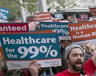 In the April 26, 2017, file photo, supporters of single-payer health care march to the Capitol in Sacramento, Calif. Large majorities of young Americans want to see an expansion of government services, including a single-payer health care program, according to a new poll by The Associated Press-NORC Center for Public Affairs Research and MTV.