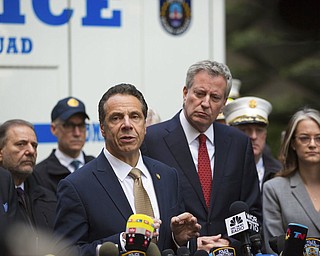 Mayor Bill de Blasio looks on as Gov. Andrew Cuomo delivers remarks during a news conference after NYPD personnel removed an explosive device from Time Warner Center on Wednesday, Oct. 24, 2018, in New York. The U.S. Secret Service says agents have intercepted packages containing "possible explosive devices" addressed to former President Barack Obama and Hillary Clinton.