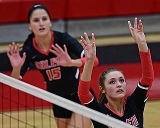 SALEM, OHIO - OCTOBER 24, 2018: Salem's Josie Miller sets the ball while Abbie Cochran watches during their OHSAA Division III Tournament volleyball match, Wednesday night at Salem High School. DAVID DERMER | THE VINDICATOR