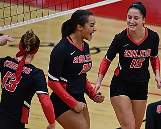 SALEM, OHIO - OCTOBER 24, 2018: Salem's Echo Mayer-Kutz, center, celebrates with Abie Cochran, right, and Mackenzie Jeric after scoring a point during their OHSAA Division III Tournament volleyball match, Wednesday night at Salem High School. DAVID DERMER | THE VINDICATOR