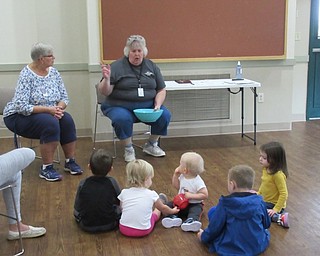Neighbors | Jessica Harker.Naturalists Lynn Zocolo and Brenda Markley taught preschoolers about how potatos grow at the Metro Parks Farms Sept. 25.