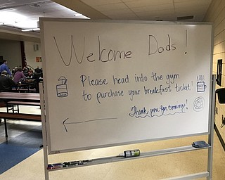Neighbors | Jessica Harker .A sign welcomed dads to the Donut for Dads event at Austintown Intermediate School in the cafeteria.