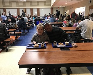 Neighbors | Jessica Harker .Maleah and Sean Bailey are pictured at a doughnut breakfast together at Austintown Intermediate School on Oct. 15 during the schools Donuts for Dads event.