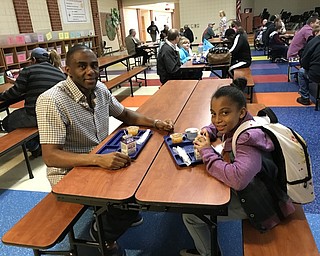 Neighbors | Jessica Harker .Ivan and Malia Thomas ate breakfast together for the Donuts for Dads event at Austintown Intermediate School on Oct. 15.