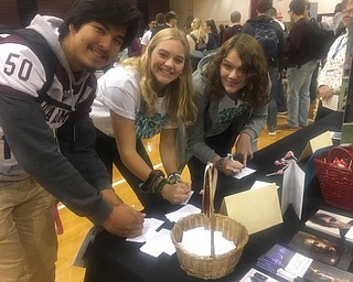 Neighbors | Submitted.Kenny Reece, Kenzie Widrig and Payton Melia all signed up for information from the Butler Art Museum on Oct. 19 at Boardman High School's annual Yes Fest event.
