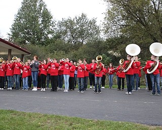 Neighbors | Abby Slanker.Canfield Village Middle School eighth-grade band members, under the direction of CVMS Band Director James Volenik, warmed up for their performance at the Canfield Cardinals versus Howland Tigers football game on Oct. 19. The band members then joined the Canfield High School marching band for their pre-game and halftime performances.