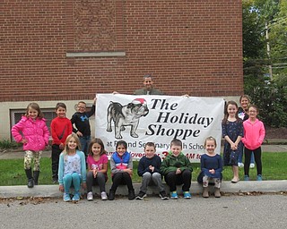 Neighbors | Jessica Harker.Students at Poland Union Elementary prepared for the schools annual PTO fundraiser the Holiday Shoppe. Pictured are, from left, (front) Avery Munford, Annabelle Munford, Milana Kalouris, Connor Henderson, Jaden Jones, Lexi Canter; (back) Chloe Garcia, Stone Garcia, Zach Armbrecht, Principal Mike Masucci, Kristina Cushner, Capri Carchedi and Aliyana Broderick.