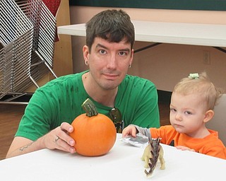 Neighbors | Jessica Harker .James and Emily Kirtos chose from a handful of decorations for the pumpkins they picked at the Metro Park Farms pumpkin patch Oct. 6.