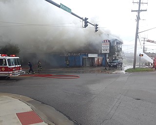 Firefighters are at the scene of a large fire at a building at Mahoning Avenue and Four Mile Run Road.