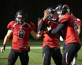 DIANNA OATRIDGE | THE VINDICATOR  Canfield's Mehlyn Clinkscale (4) celebrates with teammates Colin Hritz (8) and Vince Giordano (55) after scoring a touchdown during their 34-7 victory against Poland in the Battle of 224 at Bob Dove Field in Canfield on Friday.