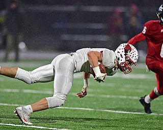 AUSTINTOWN, OHIO - OCTOBER 26, 2018: Mooney's Jason Santisi falls forward for extra yardage in front of Fitch's Deondre' McKeever during the first half of their game, Friday night at Austintown Fitch High School. DAVID DERMER | THE VINDICATOR
