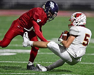 AUSTINTOWN, OHIO - OCTOBER 26, 2018: Mooney's Nico Marchionda is hit by Fitch's Corey Vernon after a reception during the first half of their game, Friday night at Austintown Fitch High School. DAVID DERMER | THE VINDICATOR