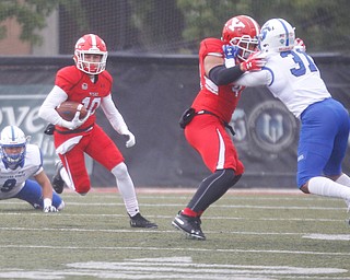 YSU's Jake Coates runs with the ball while Curtis Parks blocks Indiana State's Esdras Simervil during their game at Stambaugh Stadium on Saturday. EMILY MATTHEWS | THE VINDICATOR