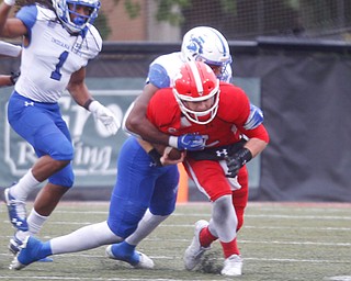 YSU's Montgomery VanGorder gets tackled by Indiana State's Jonas Griffith during their game at Stambaugh Stadium on Saturday. EMILY MATTHEWS | THE VINDICATOR