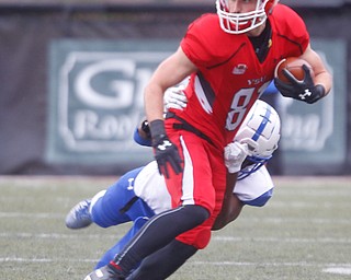 YSU's Ryan Emans runs with the ball as Indiana State's Dwayne Thompson II tries to tackle him during their game at Stambaugh Stadium on Saturday. EMILY MATTHEWS | THE VINDICATOR